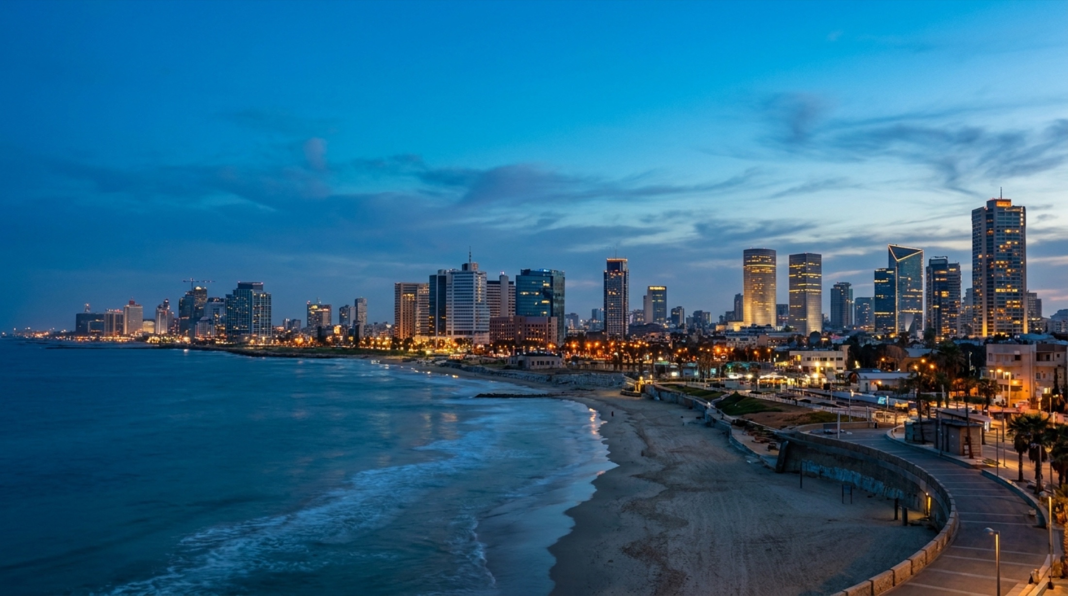 Tel Aviv skyline at dusk along the Mediterranean coast